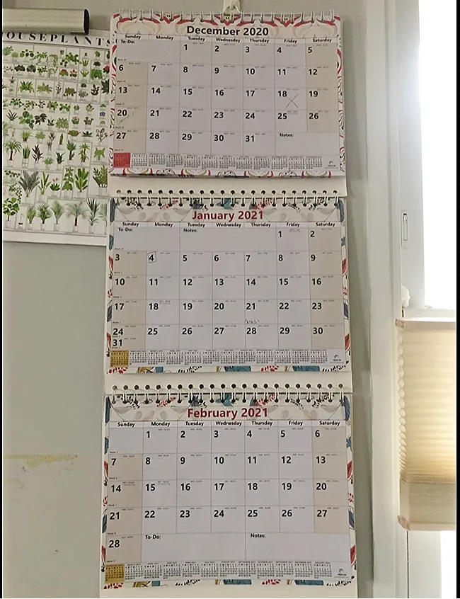 3 month wall calendar hanging on a wall
